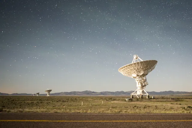 dishes of a radio telescope array at night